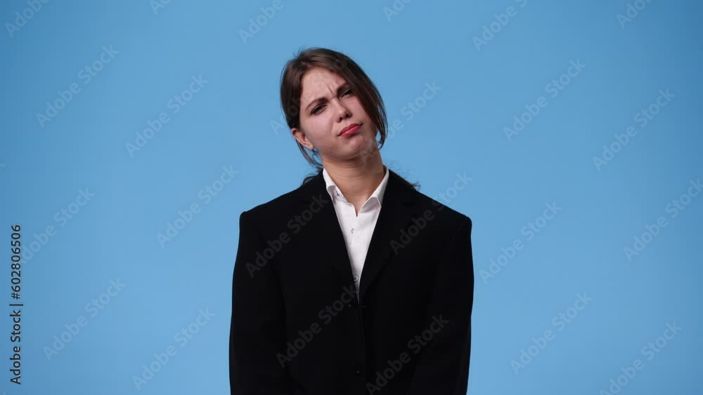 4k video of one girl with negative facial expression over blue background. 4k video of one girl with negative facial expression over blue background.