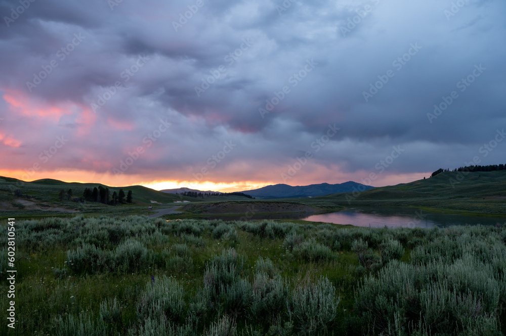 Sun Fades Behind Thick Clouds At Sunet In Hayden Valley