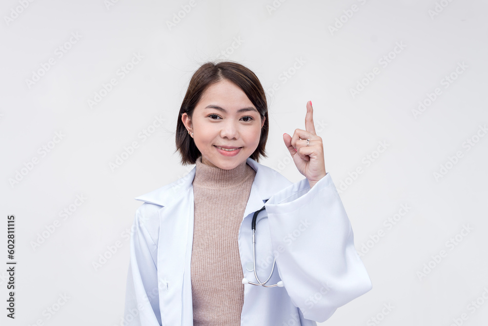 Portrait of a young and skilled doctor, medical student, intern, posing while pointing upwards. Isolated on a white background. Portrait of a young and skilled doctor, medical student, intern, posing while pointing upwards. Isolated on a white background.