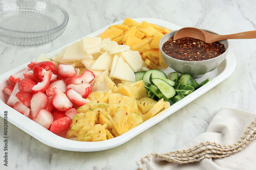 Rujak Buah Coel, Sliced Fruit with Spicy and Sweet Peanut Sauce.