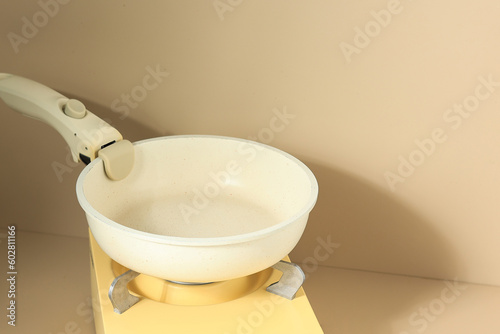 White Pan on Yellow Mini Stove, Cooking Preparation. photo