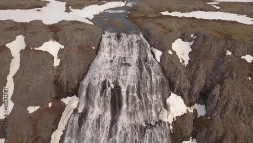 Aerial Drone view of Baejarfoss Falls in Westfjords Iceland with snow and waterfall photo
