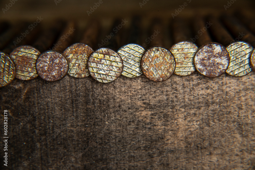 old rusty, 16 penny nail heads, line of heavy penny nails for construction and carpentry, building, creating, antique, old, grandfathers building tools, wood and nail background old rusty, 16 penny nail heads, line of heavy penny nails for construction and carpentry, building, creating, antique, old, grandfathers building tools, wood and nail background
