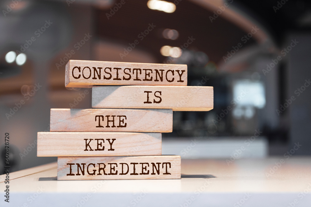 Wooden blocks with words 'Consistency is the key ingredient'.