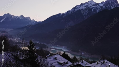 Tilting up from Pieve di Cadore village in Italy to Dolomites mountains photo