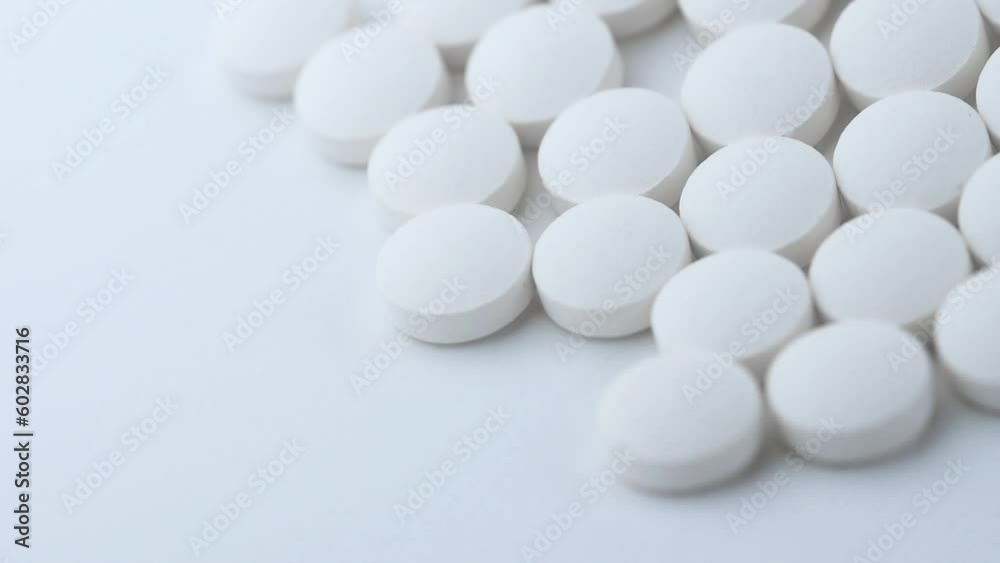 White medical pills closeup. Pills and drugs. Pharmaceutical Industry. The medicine concept. White medical pills closeup. Pills and drugs. Pharmaceutical Industry. The medicine concept.