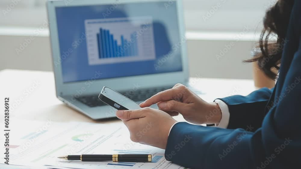 Asian Business woman using calculator and laptop for doing math finance on an office desk, tax, report, accounting, statistics, and analytical research concept Asian Business woman using calculator and laptop for doing math finance on an office desk, tax, report, accounting, statistics, and analytical research concept