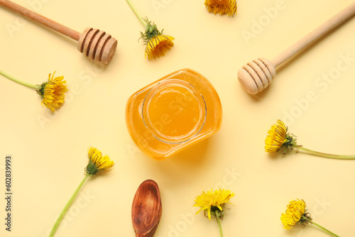 Jar of golden honey with wo...