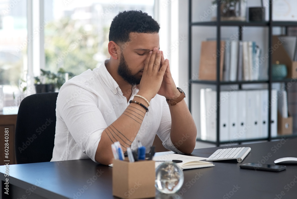 Stress, burnout and tired with a business man at his desk in an office feeling the pressure of a project deadline. Headache, fatigue and frustrated with an exhausted male employee overwhelmed by work