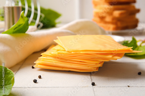 Slices of tasty processed cheese on table photo