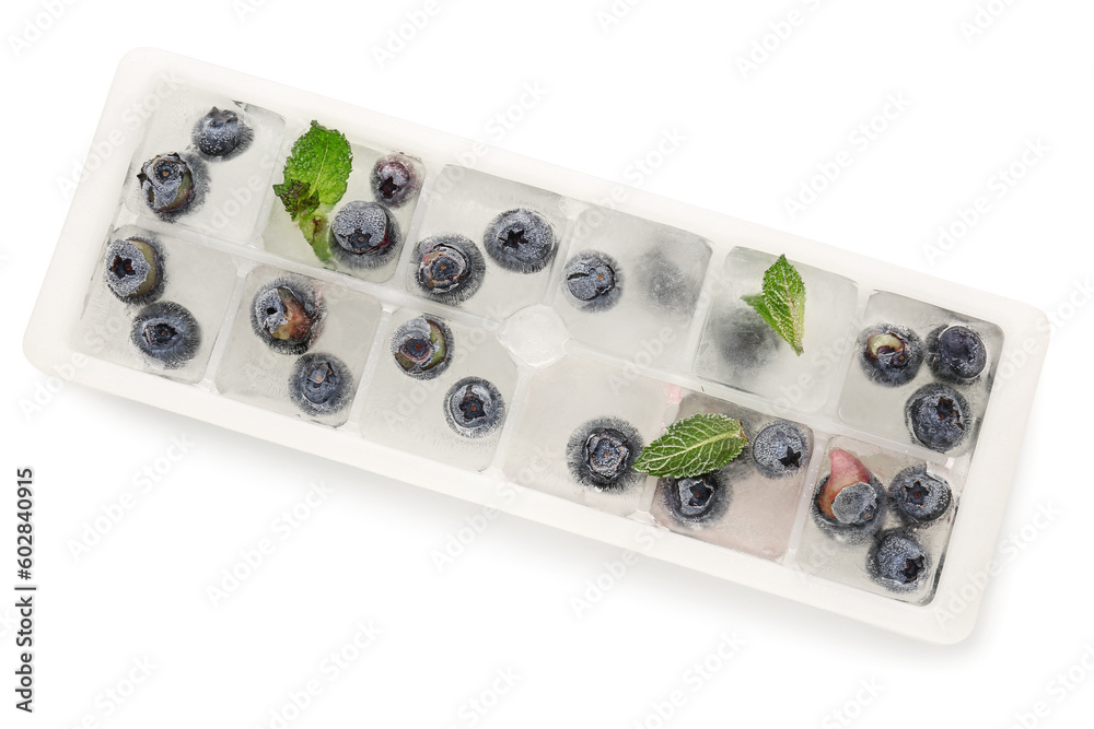 Ice tray with fresh blueberry frozen in ice on white background Ice tray with fresh blueberry frozen in ice on white background