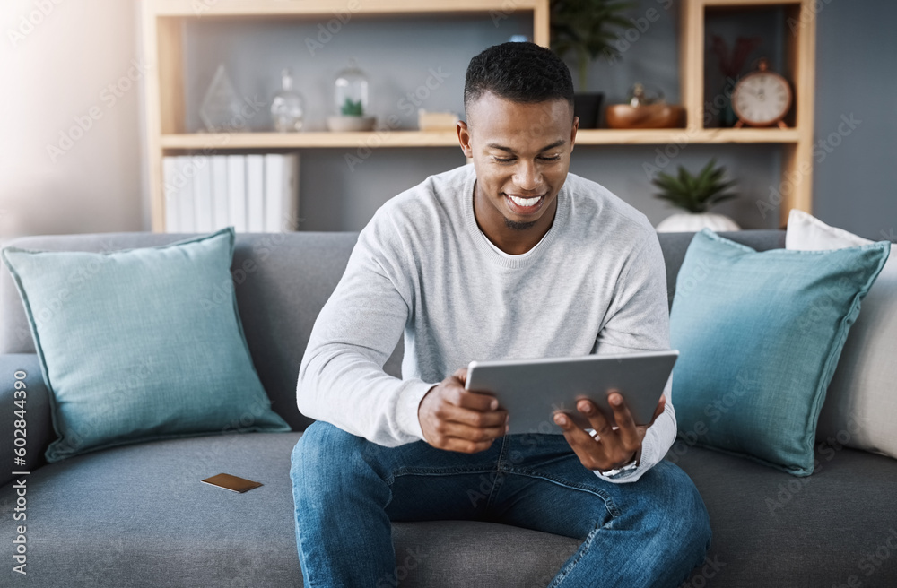 Online shopping, tablet and credit card, happy man on sofa reading website discount sale info or promotion. Happiness, internet and payment, male with smile on face and ecommerce subscription service Online shopping, tablet and credit card, happy man on sofa reading website discount sale info or promotion. Happiness, internet and payment, male with smile on face and ecommerce subscription service