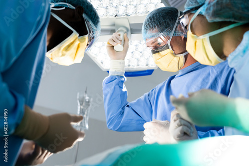 Diverse group of surgeons during surgery in operating theatre