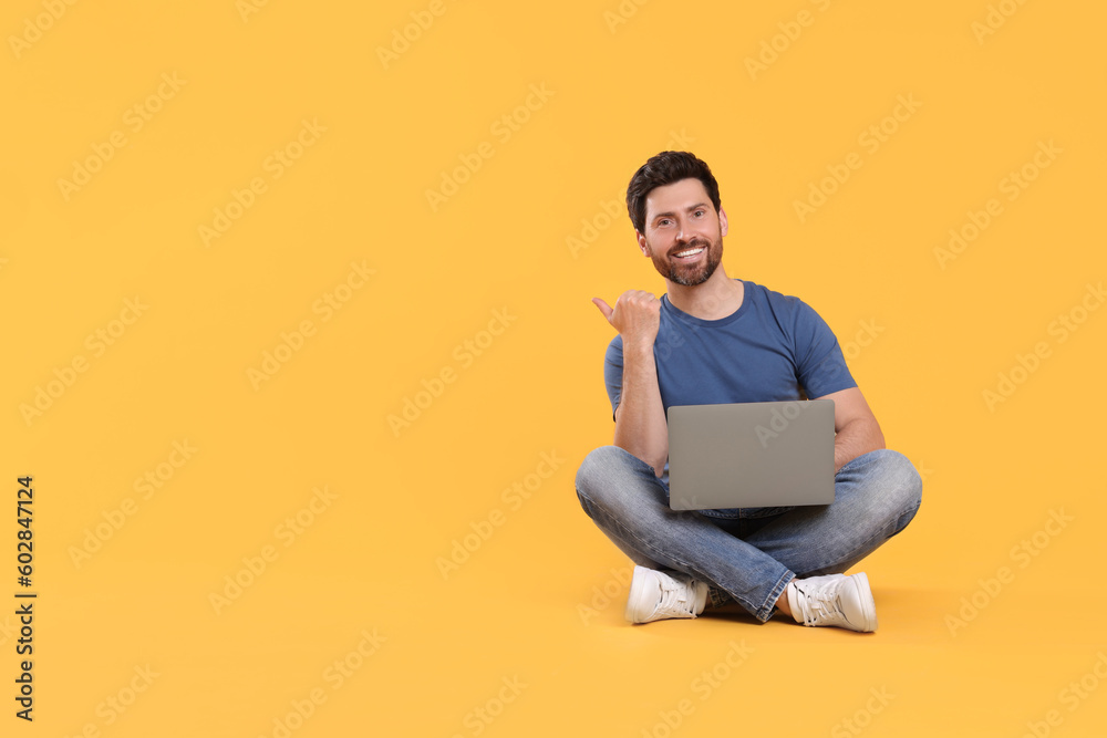 Happy man with laptop on yellow background. Space for text Happy man with laptop on yellow background. Space for text