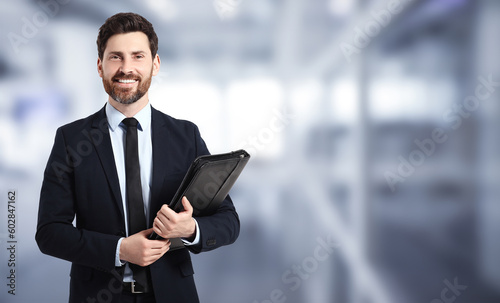 Fotografia Handsome real estate agent with portfolio in office, space for text