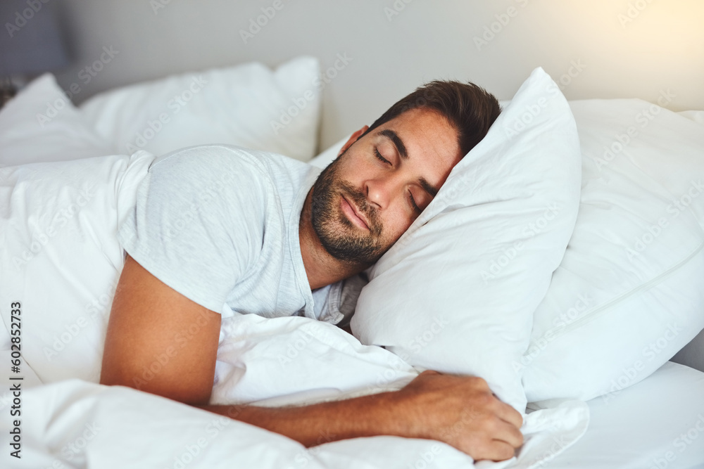 Man, sleeping and bed in morning rest for healthy wellness, peace and quiet on comfort pillow at home. Tired or exhausted male person asleep or dreaming on peaceful holiday or weekend in the bedroom Man, sleeping and bed in morning rest for healthy wellness, peace and quiet on comfort pillow at home. Tired or exhausted male person asleep or dreaming on peaceful holiday or weekend in the bedroom