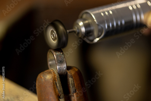 Close up of tools making jewellery, polishing ring in jewellery workshop