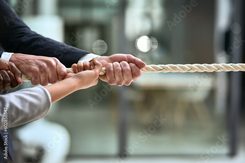 Foto Hands, teamwork and rope with business people pulling during a game of tug of war in the office