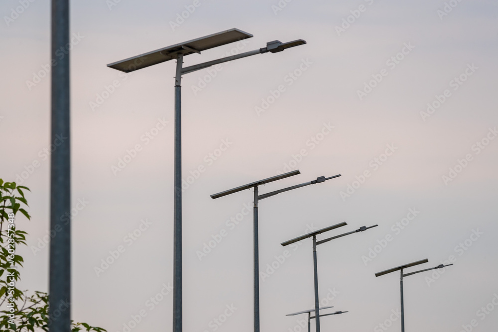 Street lights powered by solar panels. Sustainable energy. Green energy lighting. Street lights powered by solar panels. Sustainable energy. Green energy lighting.