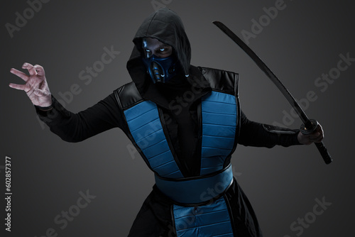 Shot of Isolated on grey background ninja with his arm outstretched.