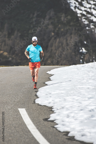 Male runner uphill on alpine pass road