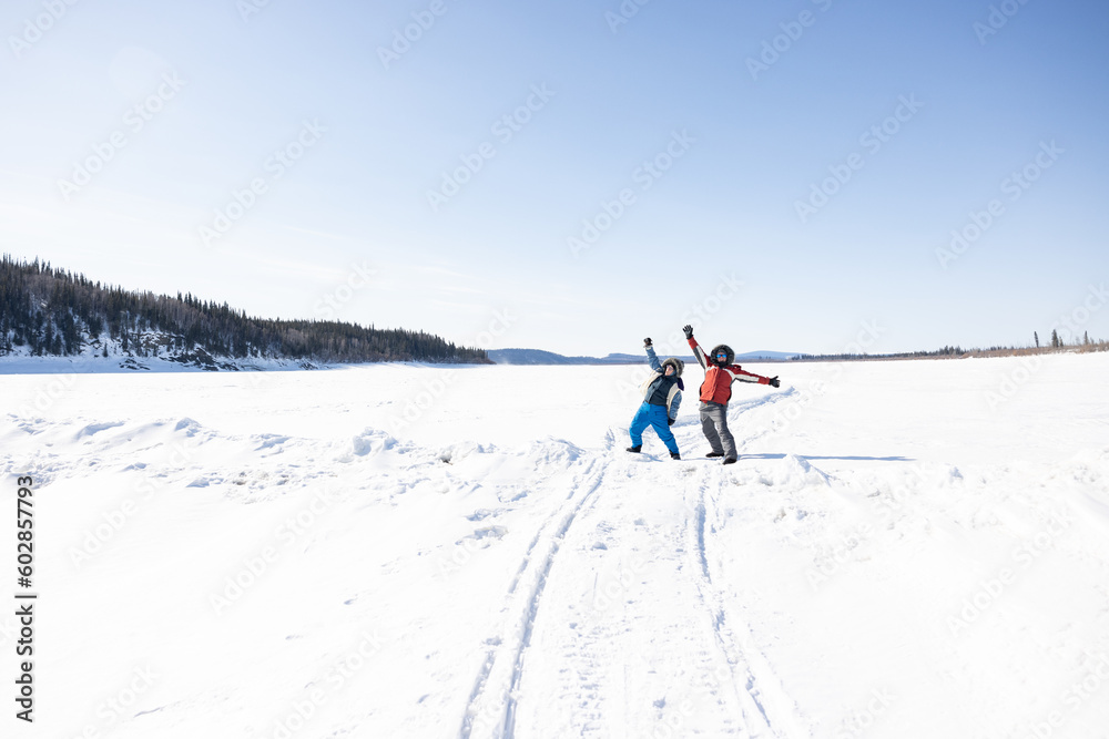 Two happy people on the frozen Yukon River in Alaska