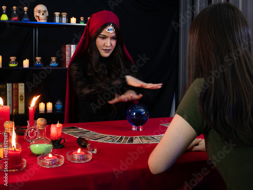Schilderij op canvas Asian sorceress woman cast a spell on magic blue crystal ball for oracle tell he