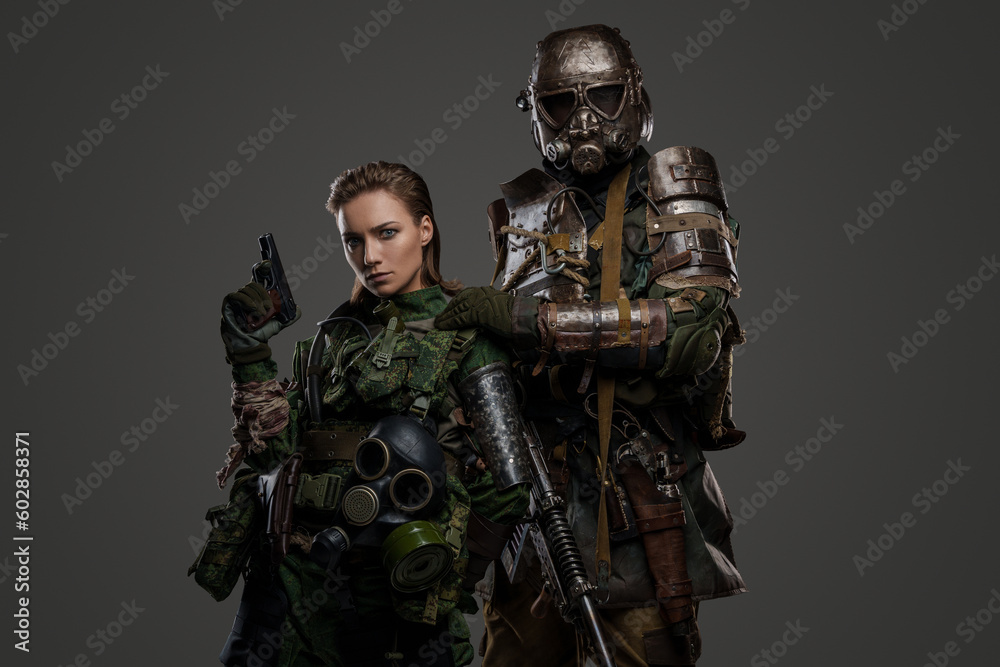 Shot of post apocalyptic people dressed in camouflage uniform against gray background.