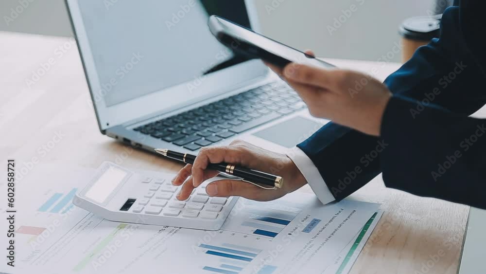 business documents on office table with smart phone and digital tablet and graph financial with social network diagram and man working in the background business documents on office table with smart phone and digital tablet and graph financial with social network diagram and man working in the background