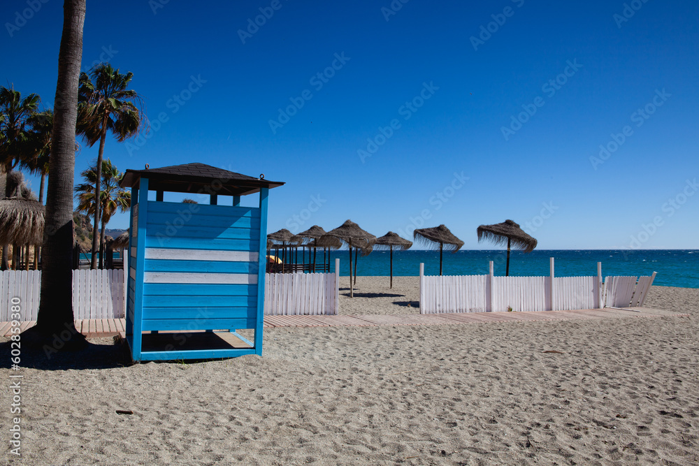 Sun umbrellas on the beach in Nerja, Spain