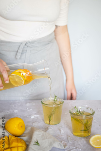 Someone pouring a glass of iced tea