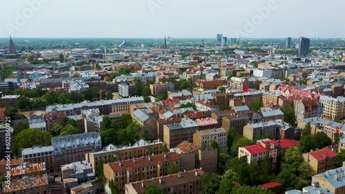 Riga Cityscape Spring Aerial Top View Video, Town, Latvia. Sunny Day Building Rooftops. Riga Skyline, Latvia, City Center, Teika, Purvciems in the Background. Architecture of the Downtown. photo