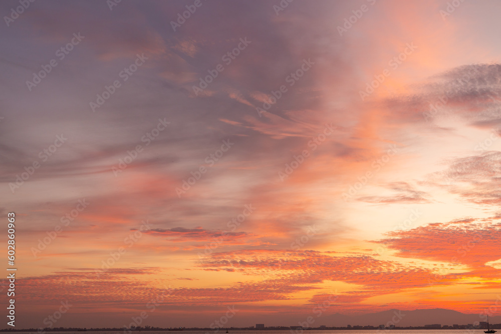 Colourful sunset sky. Full frame view of wispy colourful clouds up in the sky during sunrise or sunset hour. Sky replacement asset.