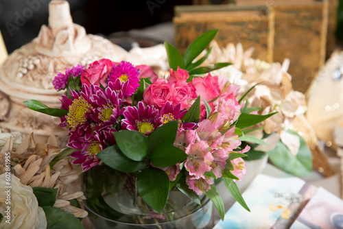 A view of a beautiful flower bouquet, featuring daisies, Inca lilies, and roses.