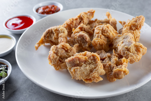 A view of a plate of Chinese deep fried chicken bites.