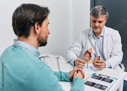 Adult man during consultation with experienced urologist about his kidney disease and treatment at medical clinic. Kidneys health photo