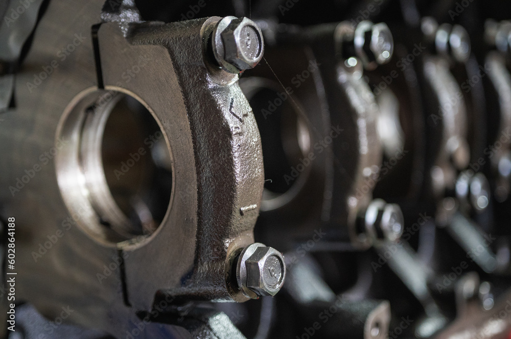 Close-up of a disassembled, engine, part of the automatic transmission box of a car on a machine in a garage or repair factory station for repair or maintenance. Detail. Close up view Close-up of a disassembled, engine, part of the automatic transmission box of a car on a machine in a garage or repair factory station for repair or maintenance. Detail. Close up view