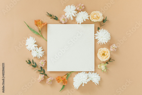 Elegant floral composition with blank square paper card in the centre. Branding  wedding mockup concept.