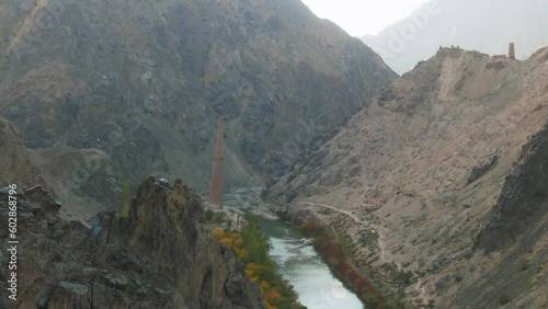 Drone flying over rocky mountains with Minaret of Jam in background, Ghowr province in Afghanistan. Aerial view photo