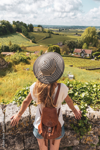 Slika na platnu Woman tourist admiring green vineyard in Bordeaux region, Saint Emilion
