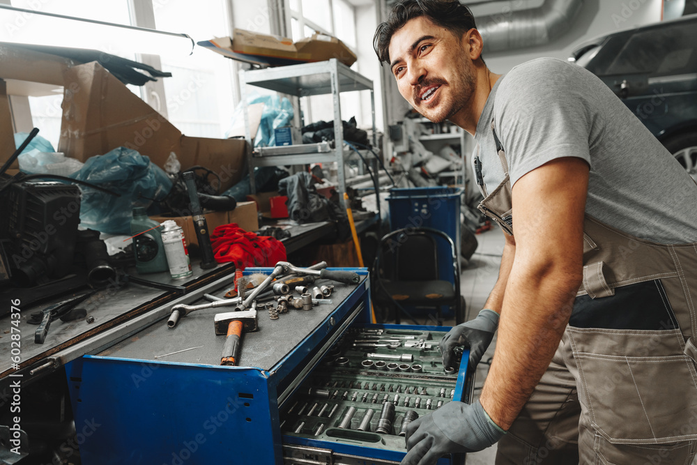 Portrait of a male mechanic in an auto repair shop Portrait of a male mechanic in an auto repair shop