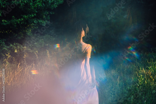 Moments of stillness. moments of self-care and self-soothing. Healing rituals and meditation. Dance Movement Therapy. Young woman dancing in nature background with reflection photo