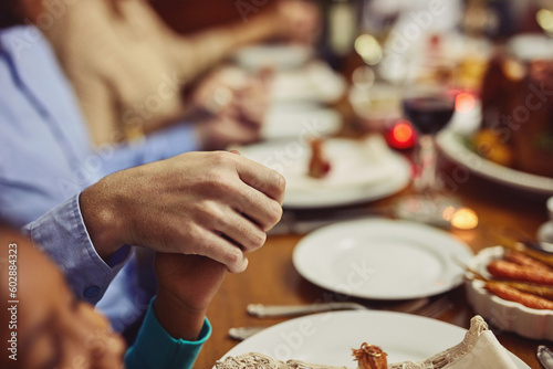 Prayer, Christmas and hand holding with family at table in dining room for holiday, food or worship. Celebration, support and gratitude with closeup of people at home for kindness, dinner and love