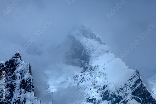 landscape photos of snow mountains blu sky and white clouds , The Karakorum is a mountain range in Kashmir region spanning the borders of Pakistan, China, and India © Tariq