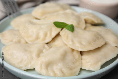Plate of delicious dumplings (varenyky) on table, closeup