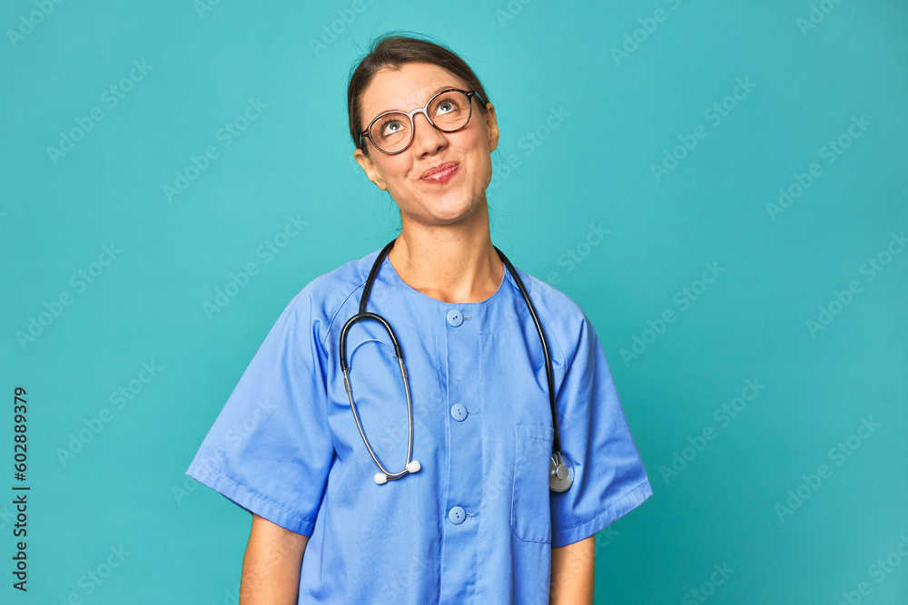 A young nurse woman isolated dreaming of achieving goals and purposes A young nurse woman isolated dreaming of achieving goals and purposes
