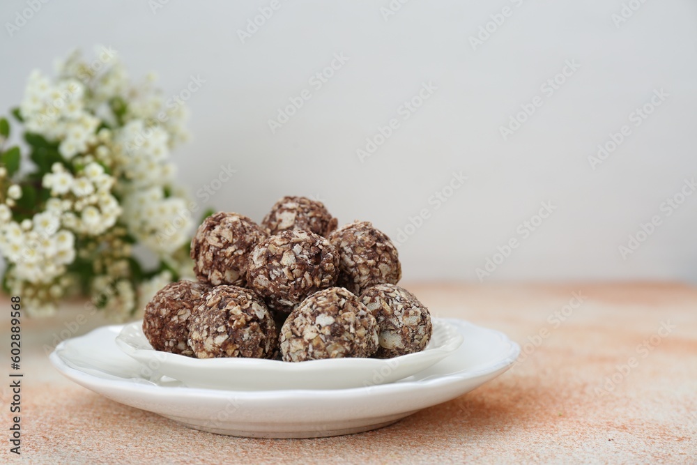Delicious sweet chocolate candies on beige table, space for text Delicious sweet chocolate candies on beige table, space for text