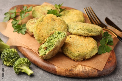 Delicious vegan cutlets with broccoli and parsley on table, closeup