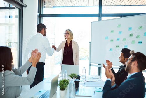 Professional, handshake and agreement in a meeting to congratulate for success and an opportunity. Presentation, applause and business people with collaboration for partnership with teamwork.