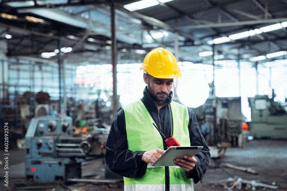 Portrait of engineer is working with tablet in the factory. Mechanical technicians are maintaining the engine. Portrait of engineer is working with tablet in the factory. Mechanical technicians are maintaining the engine.